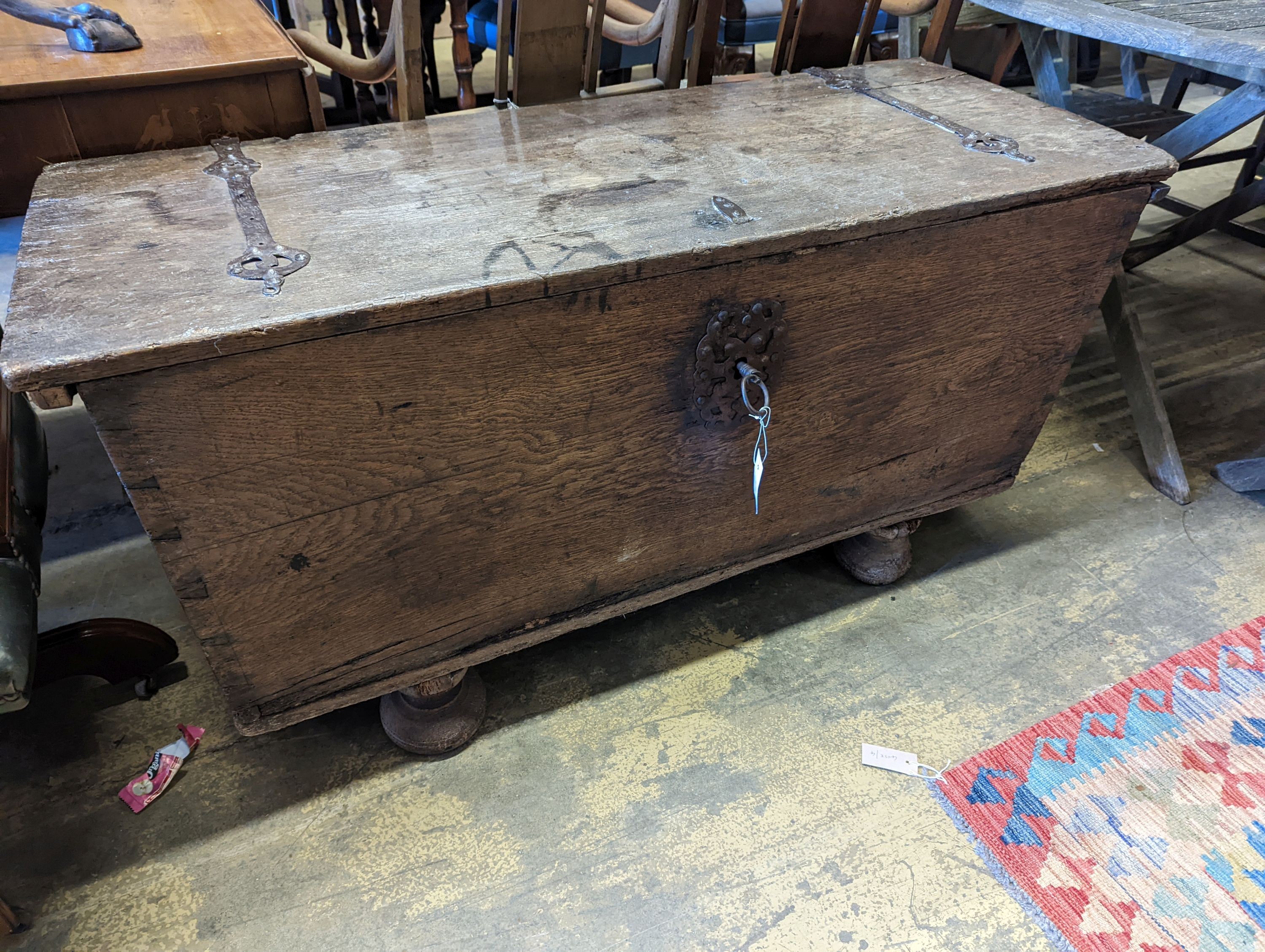 An 18th century Continental wrought iron mounted oak coffer, on pad feet, length 124cm, depth 50cm, height 66cm